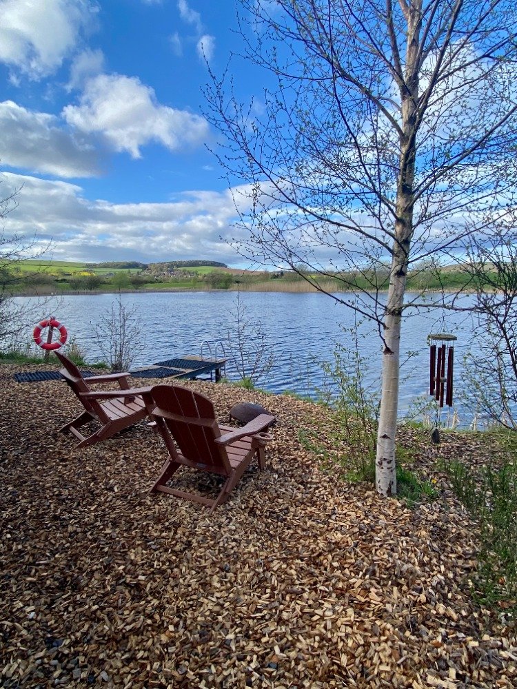 Deck chairs overlooking a loch at Eden Springs Country Park in Fife
