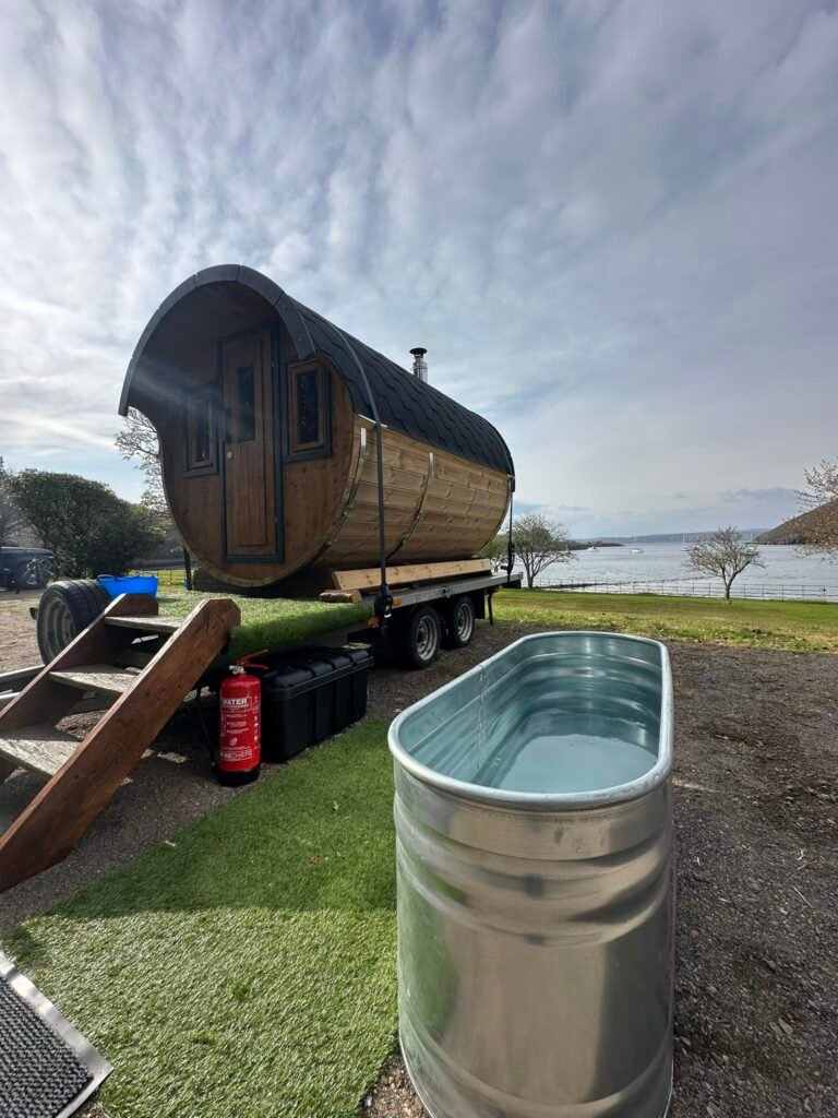 Outdoor cold plunge tub beside wood-fired sauna overlooking the water at Shieldaig Lodge