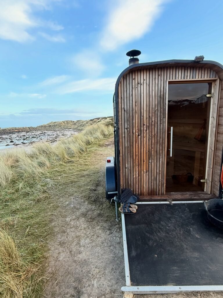 Wood-fired Fyrhùs sauna at Hopeman East Beach, set in coastal dunes with views towards the sea