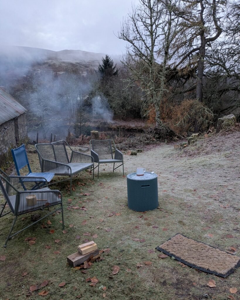 Outdoor seating area at Great Glen Sauna with chairs overlooking the Highlands, used for resting between sauna rounds