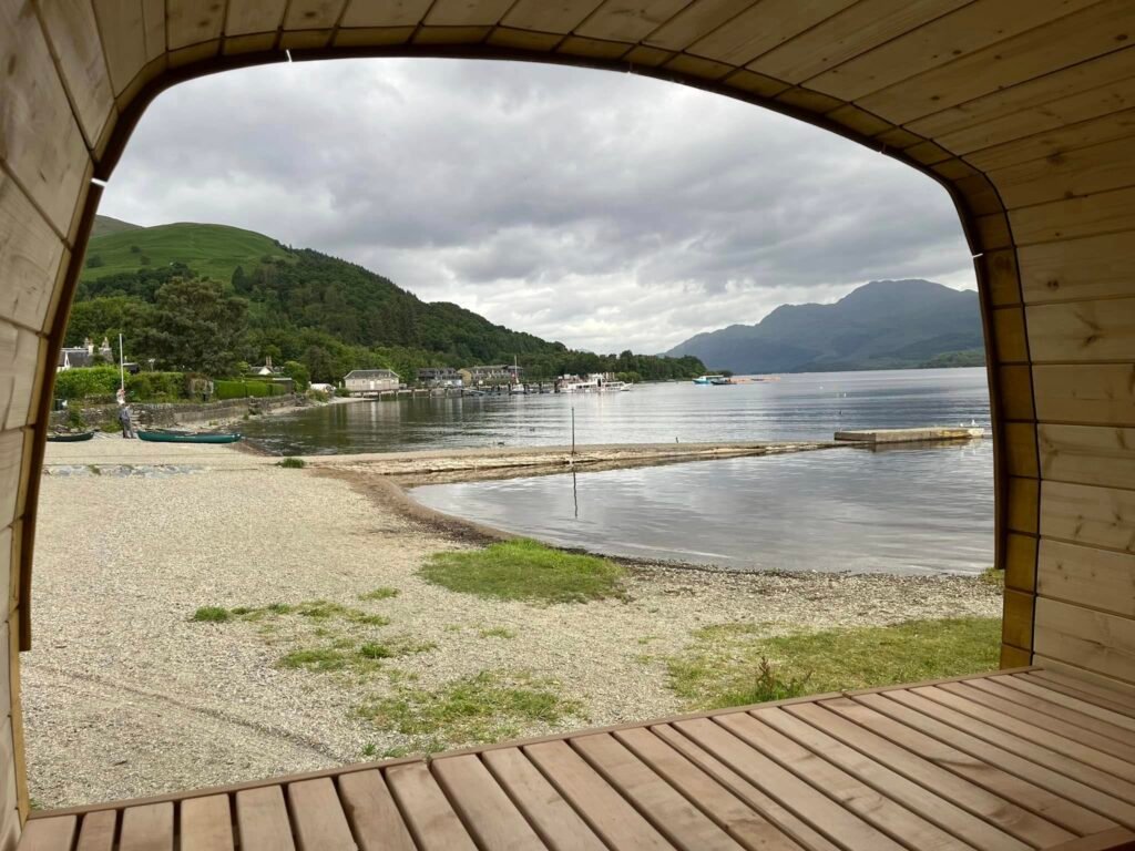 View from inside the sauna at Hot Tottie looking out over Loch Lomond and the shoreline