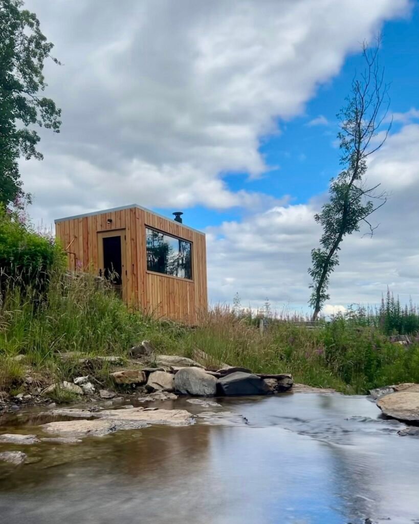 Wood-fired sauna beside a stream flowing into Loch Tay at WildEmber Bothy in Perthshire