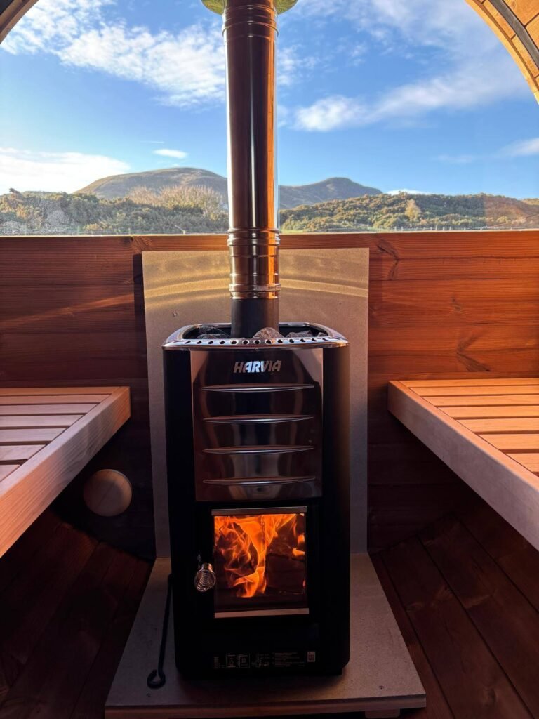 Interior of Pentland View Outdoor Sauna with wood-fired stove and views of the Pentland Hills