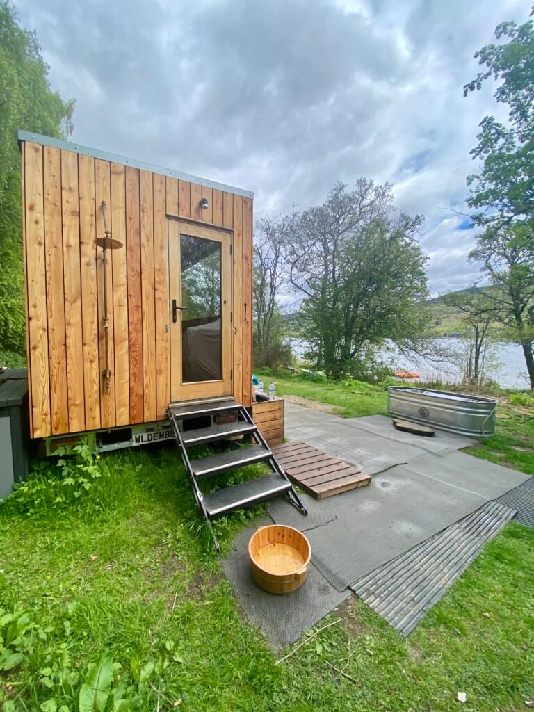 Steps leading up to Wild Ember Bothy sauna with Loch Tay in the background, Kenmore