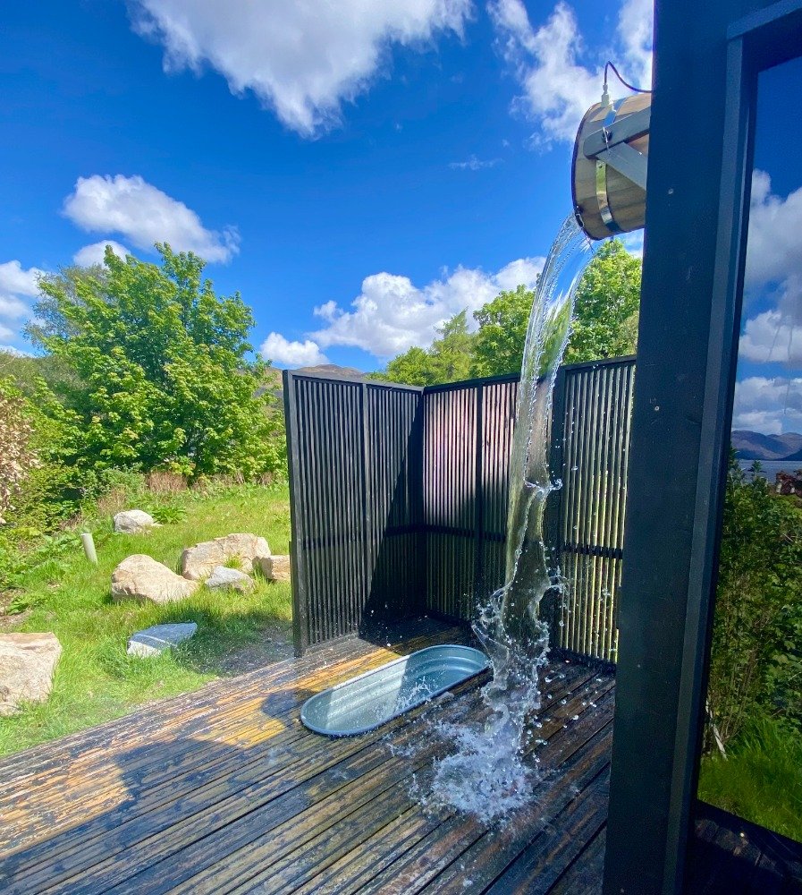 Plunge bath set flush into the decking at Wilderness Sauna, Woodlands Glencoe