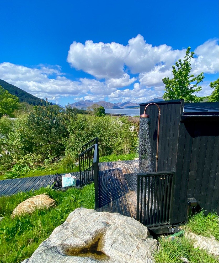 Outdoor shower at Wilderness Sauna Glencoe overlooking Loch Linnhe and mountains