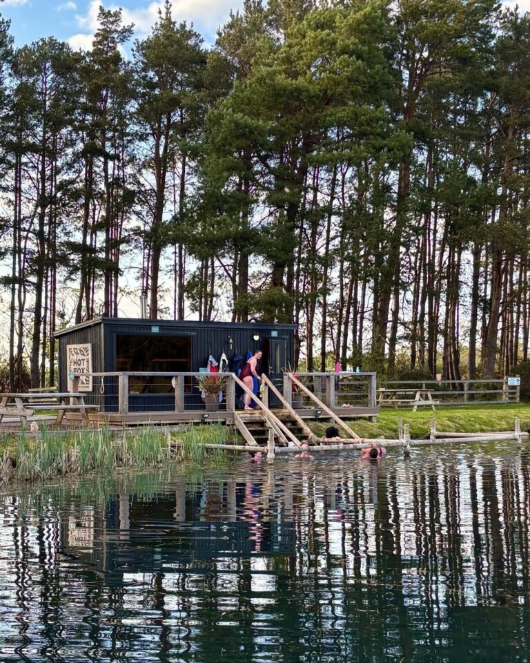 Foxlake sauna Hot Fox beside the lake with people cold plunging in woodland East Lothian