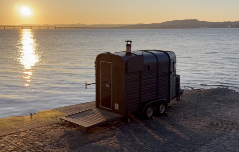 Horsebox Sauna Fife on the pier at Newport-on-Tay at sunset with the River Tay and Tay Bridge