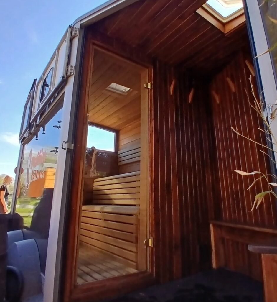 Puffin Sauna Leith horsebox sauna with door open showing wooden interior at Leith Community Croft