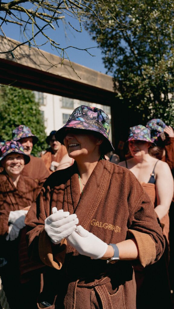 Attendees queueing in bucket hats and robes for Dan Lawson's rave Performance Aufguss at the 2026 UK Aufguss Championships