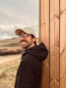 Marc, the architect and massage therapist behind Nordic Glow, Ollaberry, standing beside the Hot Hoose sauna