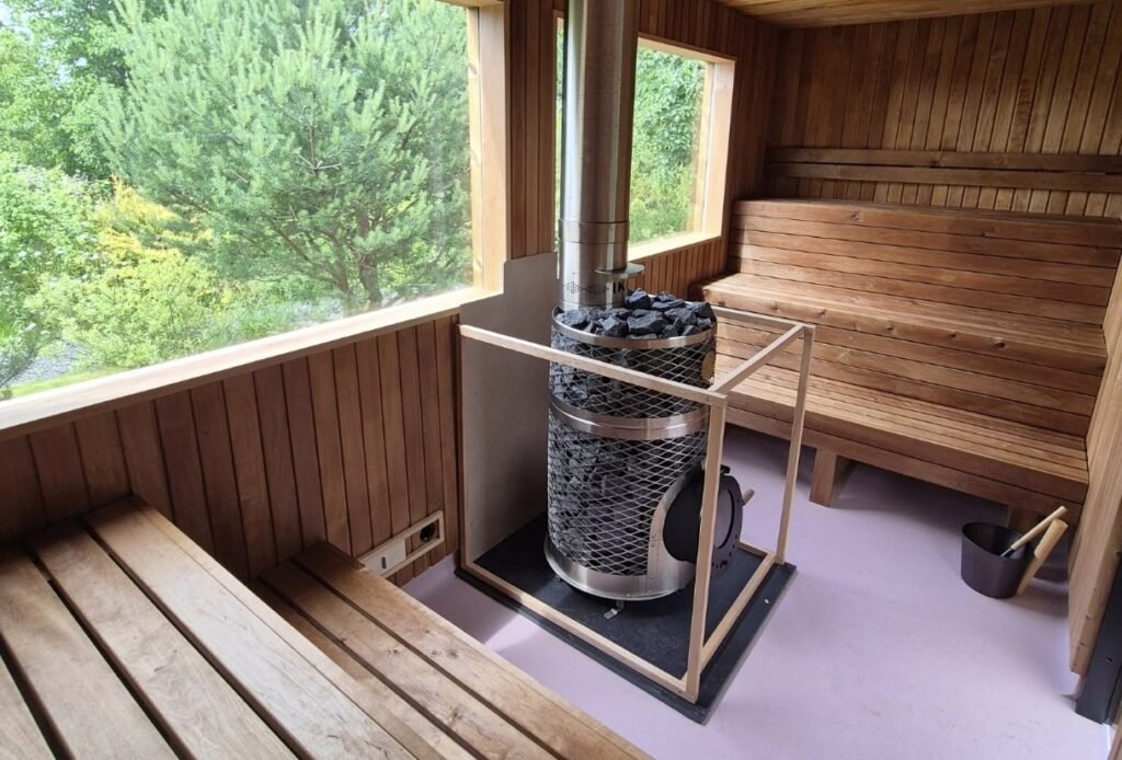 Amberwave Sauna Glasgow interior with the wood-panelled bench and stove