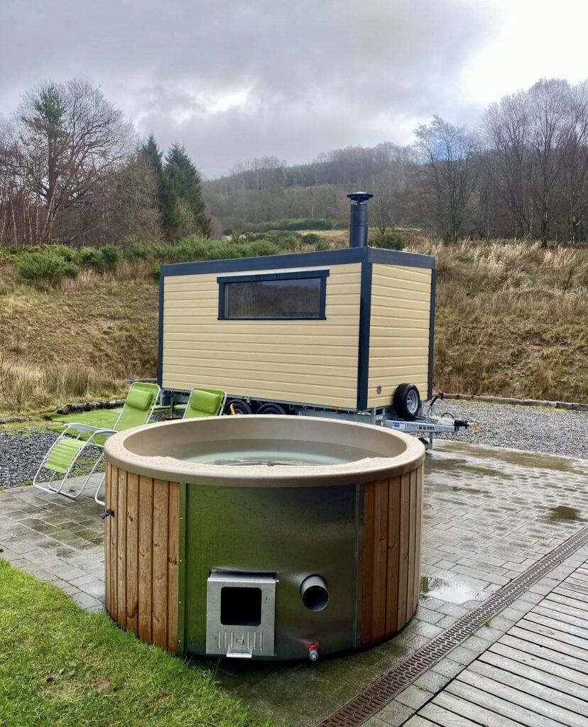 Clyde Coast Saunas Kelburn Estate trailer and hot tub set against the hills