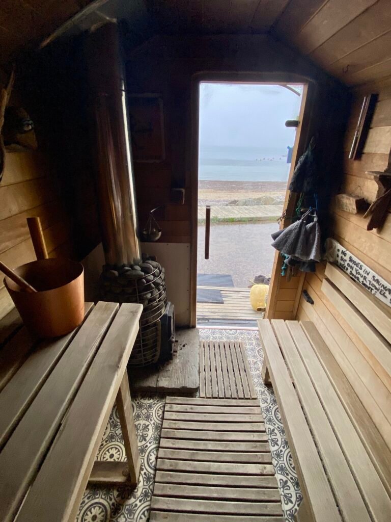 Inside Driftwood Sauna looking out through the door to the sea at Stonehaven Harbour