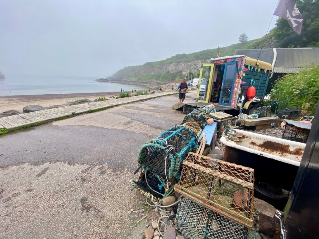 Driftwood Sauna Stonehaven on Stonehaven Harbour, with the beach and sea visible alongside it
