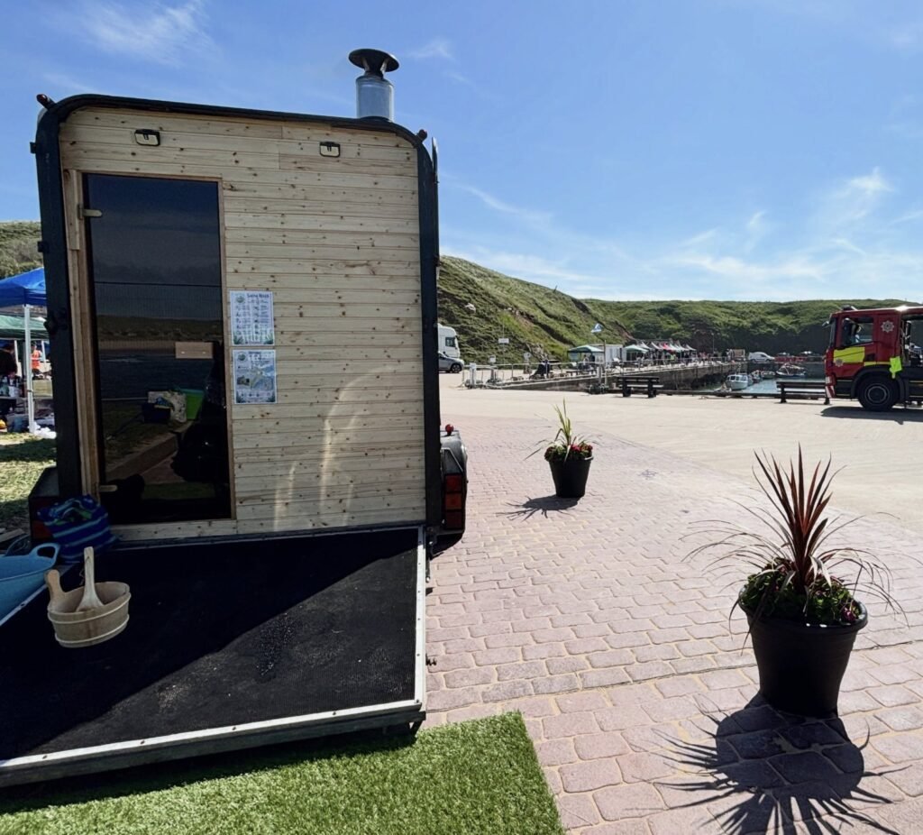 Fraileach Sauna Cruden Bay entrance with door open and wash bucket, harbour beyond