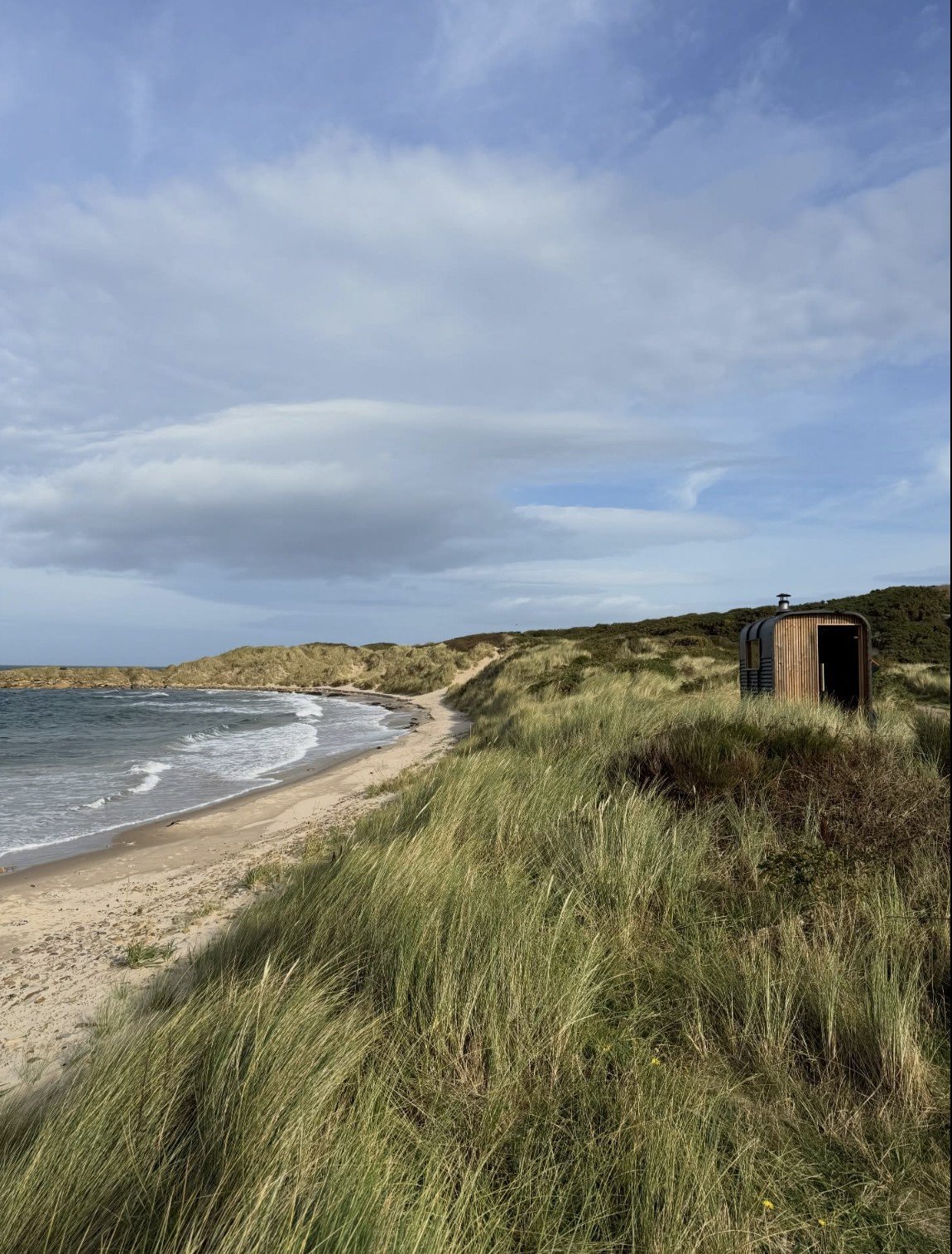 Fyrhus Sauna Hopeman set on the dunes above a sweeping sandy beach