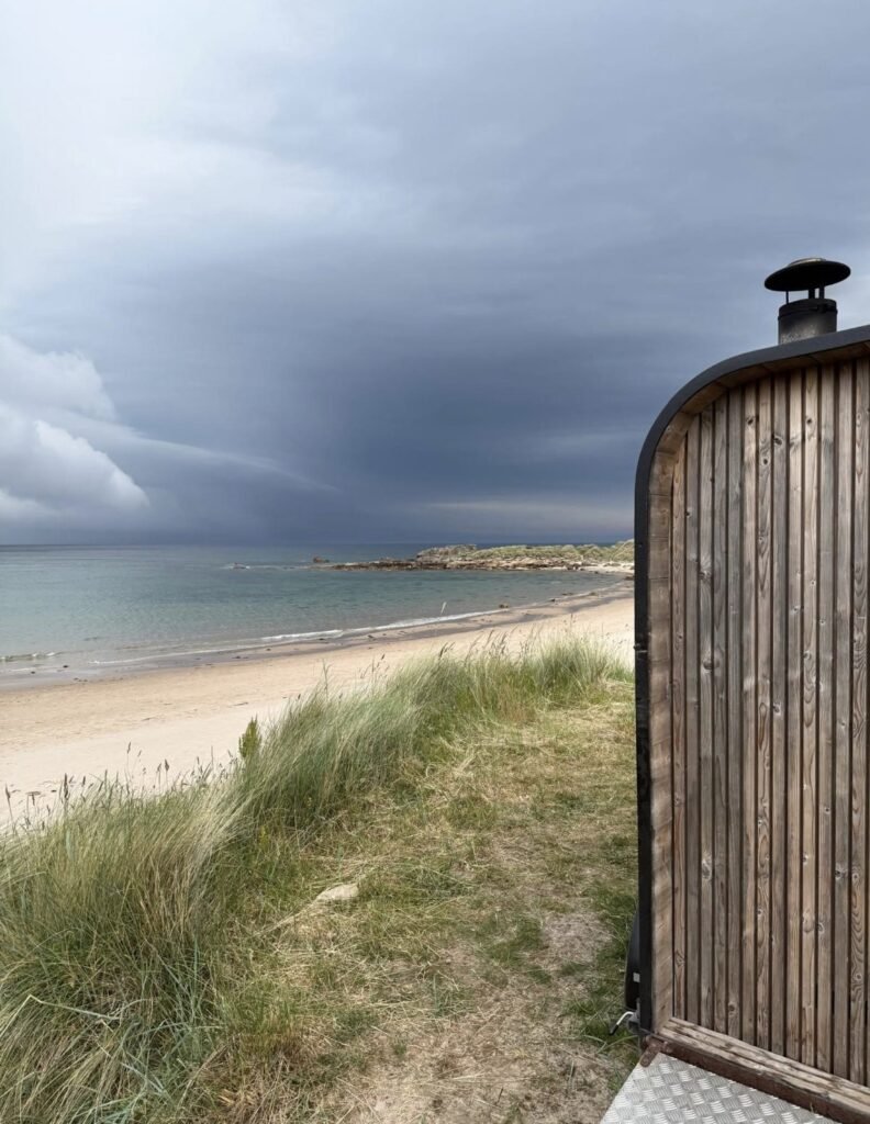 Fyrhus Sauna Hopeman with a dramatic storm rolling in over the bay