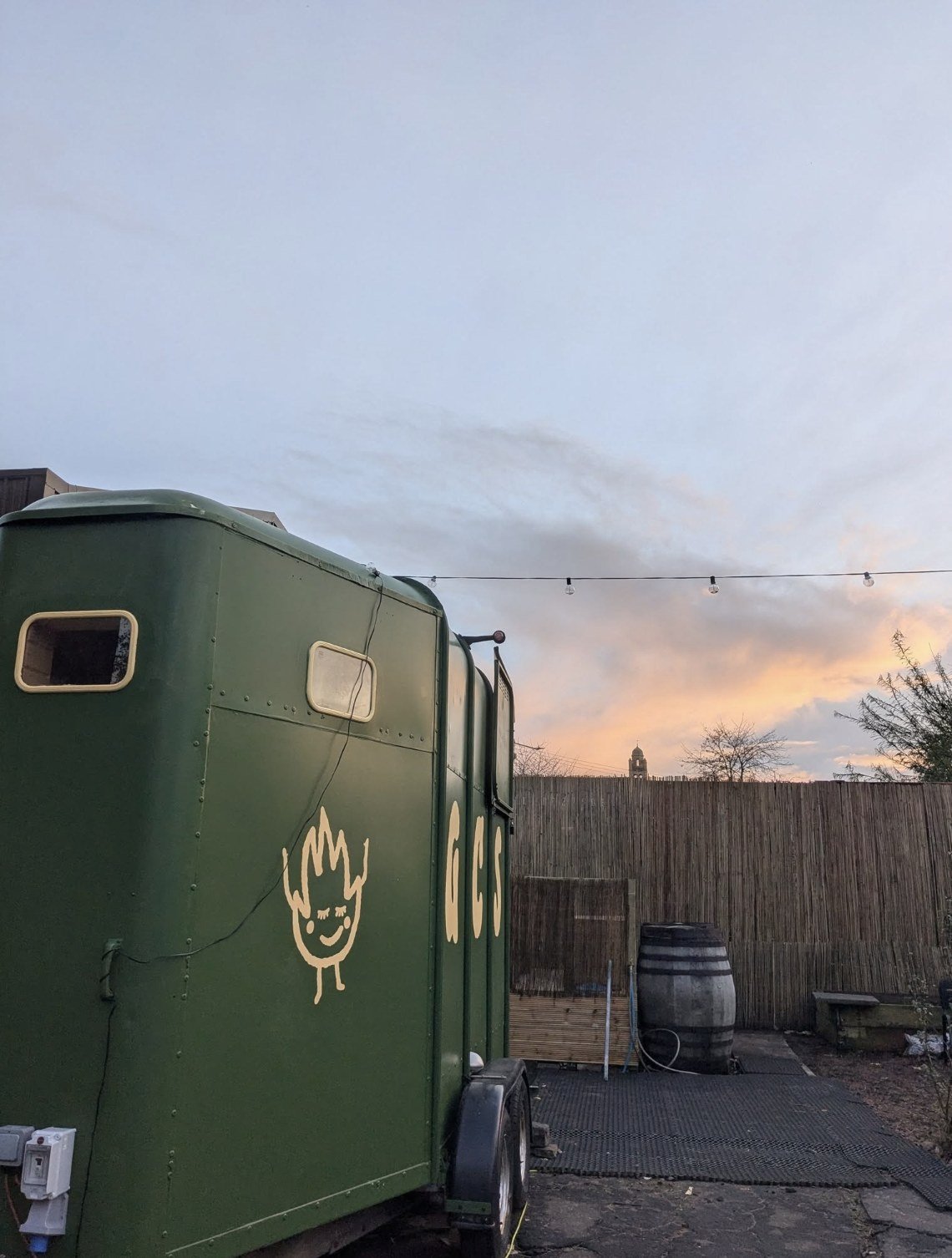 Glasgow Community Sauna Pollokshields horsebox exterior at sunset with string lights