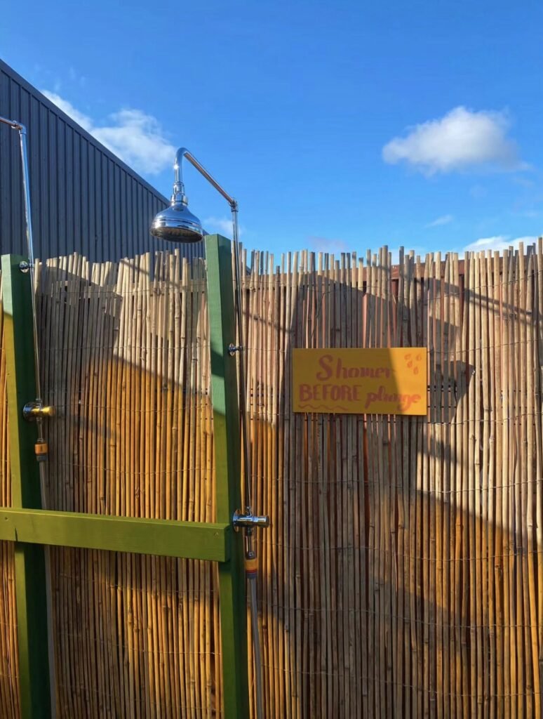 Glasgow Community Sauna Pollokshields outdoor shower with "shower before plunge" sign