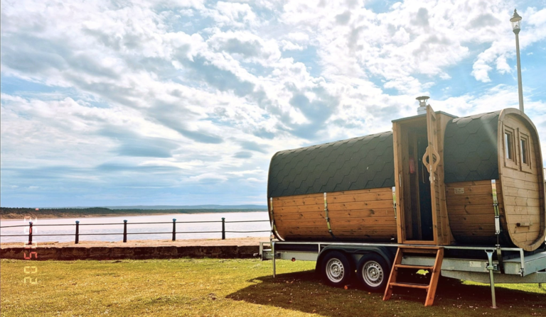 Orka Sauna, Burghead: the barrel sauna on its trailer, with wooden steps leading up to the entrance