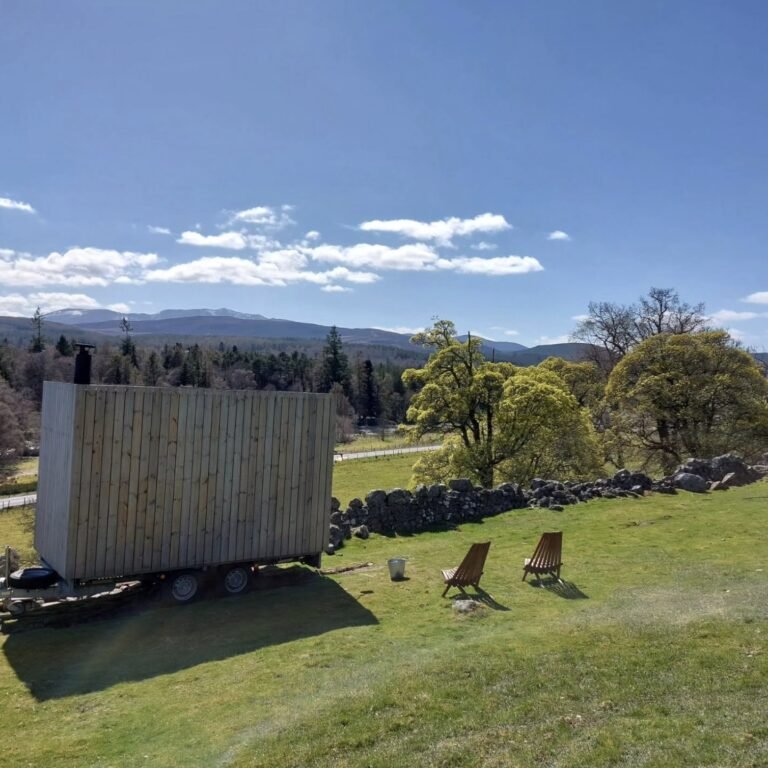 Stravaig Sauna Crathie exterior on a clear day with the Cairngorms behind