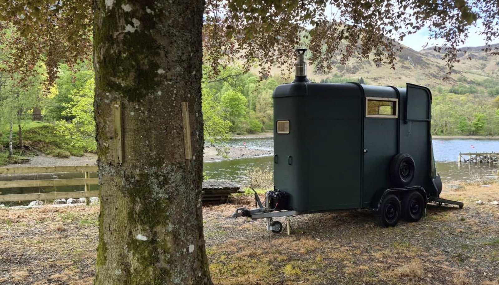 Thaw Sauna Strathearn exterior beside the loch with the Perthshire hills behind
