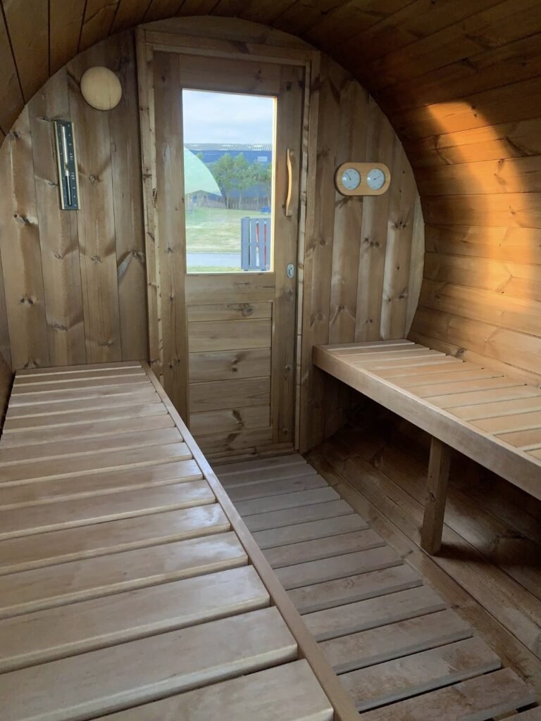 The Sauna Hoose Fraserburgh interior benches with thermometer and hygrometer, door leading outside
