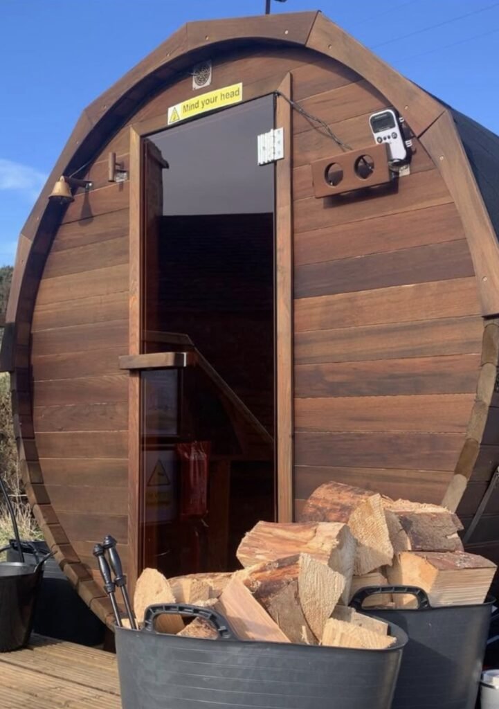 The Steamie Sauna Lossiemouth entrance with firewood stacked outside