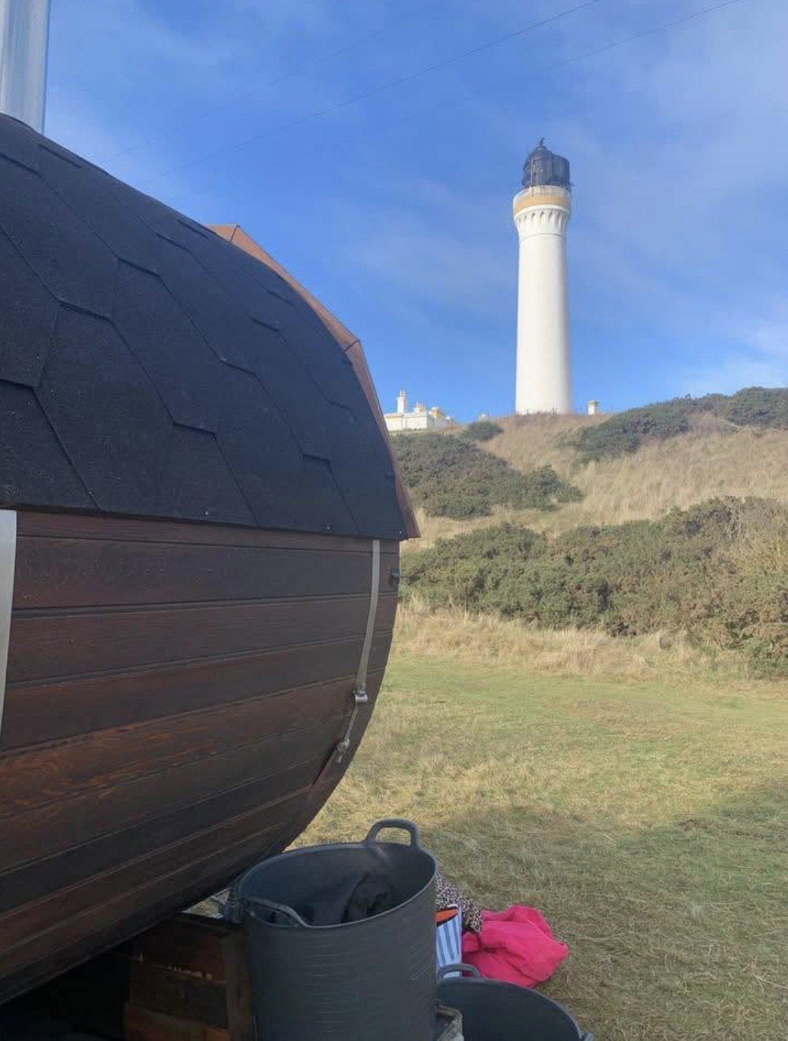 The Steamie Sauna Lossiemouth exterior with the Covesea lighthouse behind