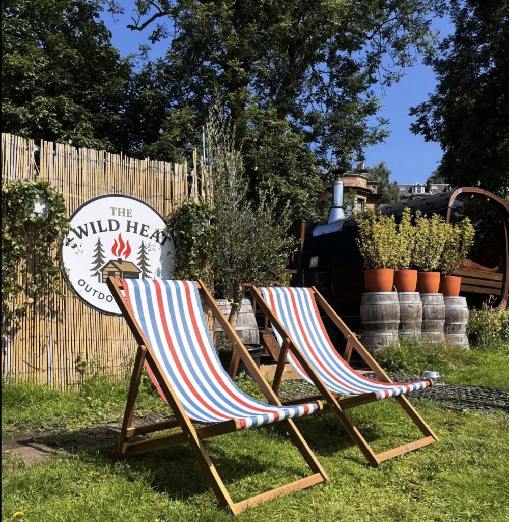 The Wild Heat Glasgow branded sign with deckchairs in the sun