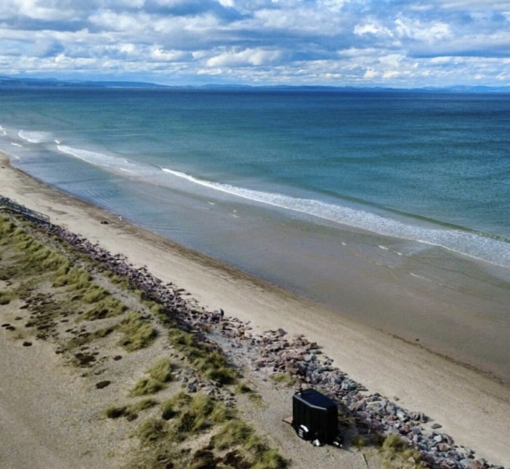 Watershed Sauna Findhorn aerial view showing the sauna set among the dunes and coastline