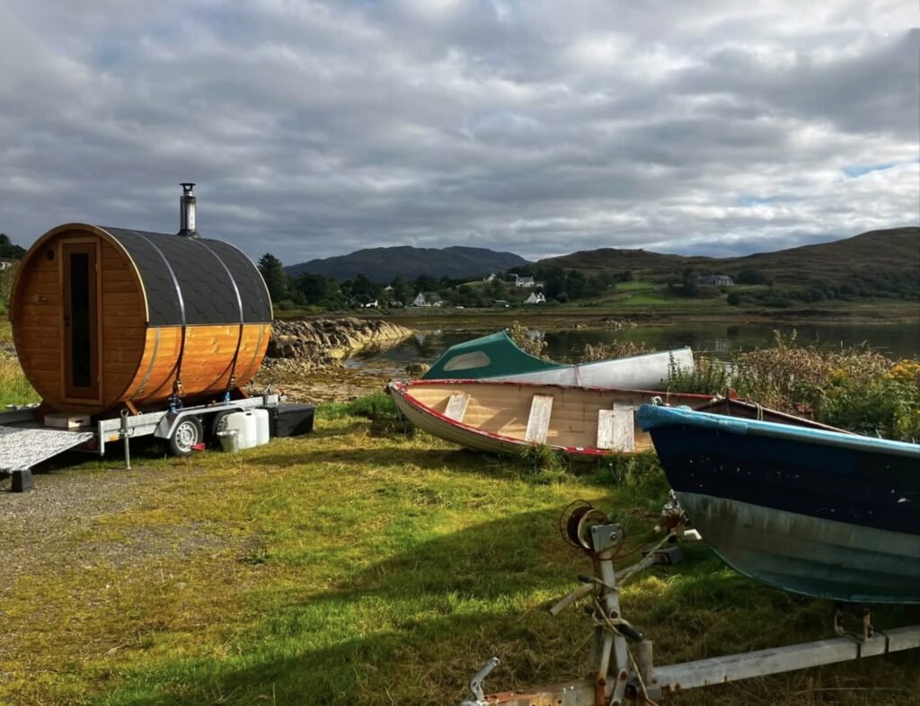 Sal Sauna Isle of Skye beside old wooden boats on the loch shore