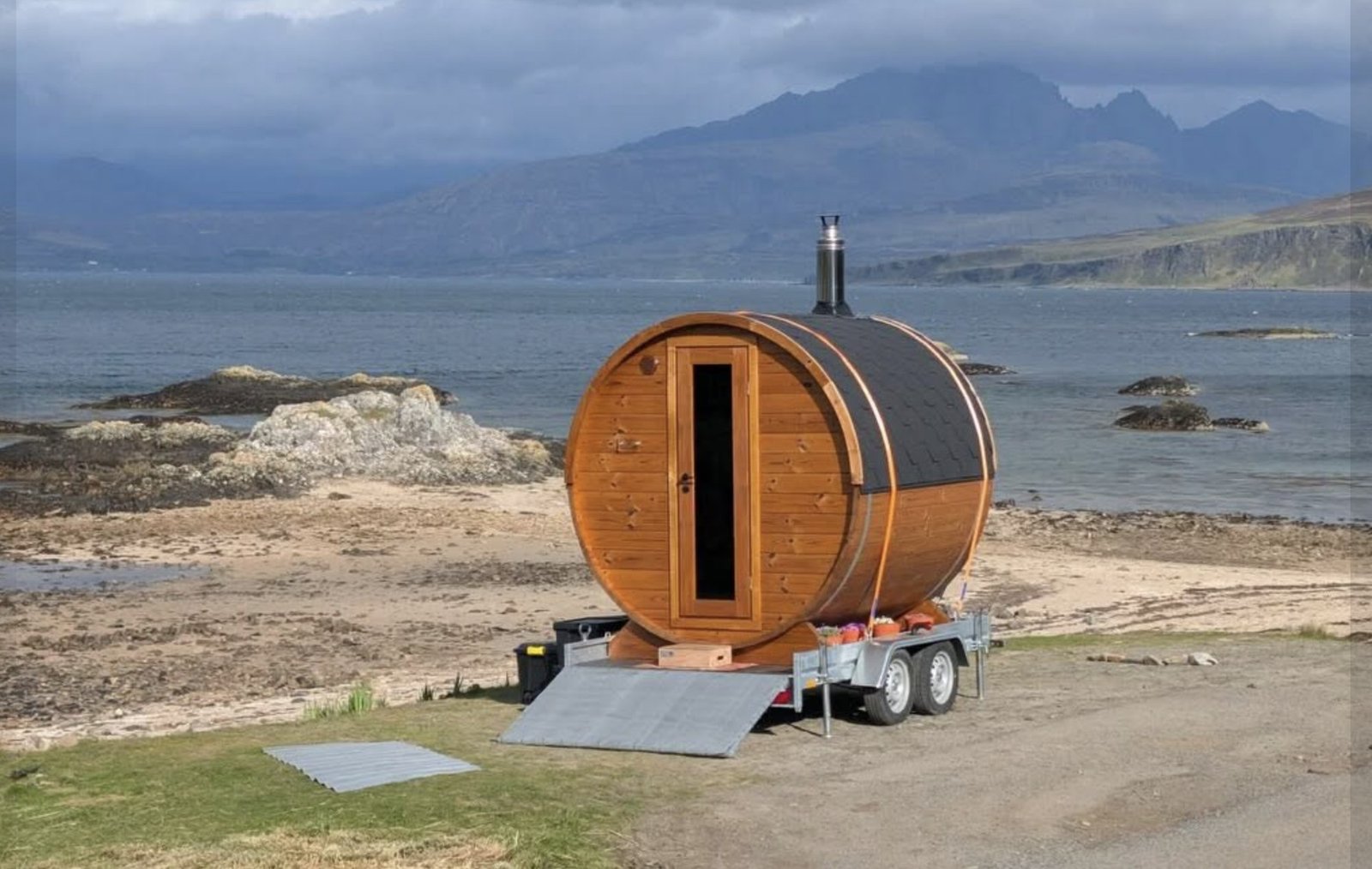Sal Sauna Isle of Skye on the beach with the Cuillins under a moody sky