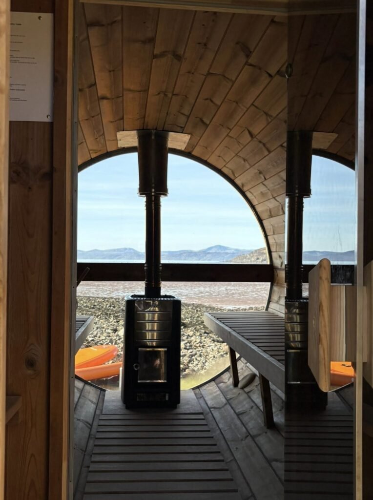 Applecross Sauna Wester Ross view from the doorway through the sauna to the round window, stove and sea beyond
