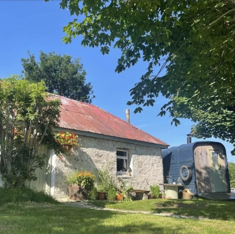 Arisaig Sauna Acharacle horsebox sauna beside the traditional stone cottage with red corrugated roof