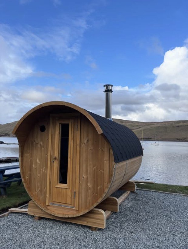 Sauna na Mara Isle of Skye wood-fired barrel sauna overlooking the loch with the Cuillin mountains behind